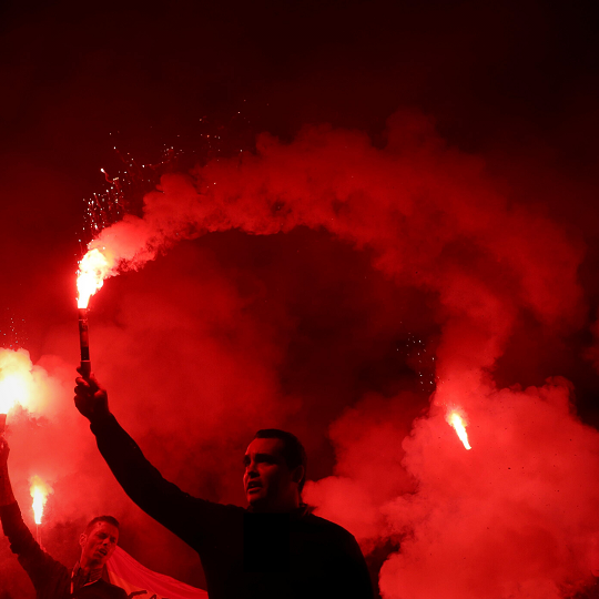 man with red flare night
