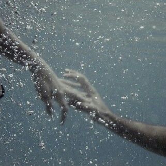 hands grasping underwater